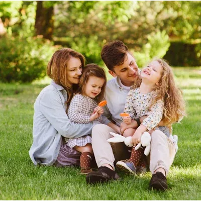 family sitting on front lawn