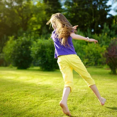 girl running outside in backyard