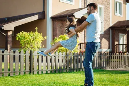 family playing outside in front yard